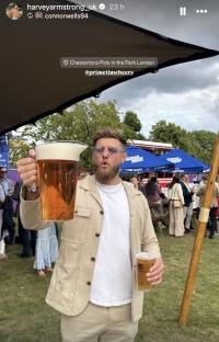 Man holding a large beer pitcher and a beer cup at Chestertons Polo in the Park.