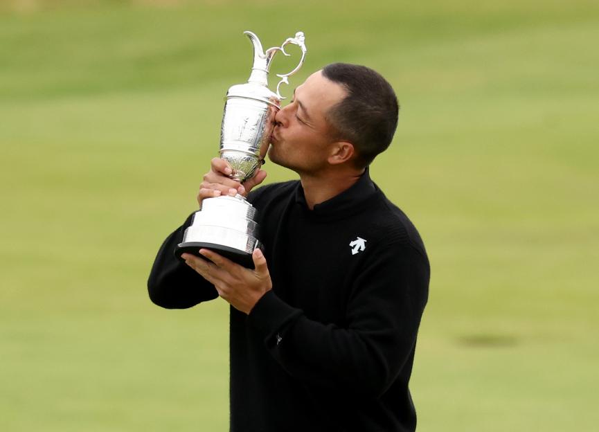 Xander Schauffele kissing the Claret Jug after winning The Open Championship.