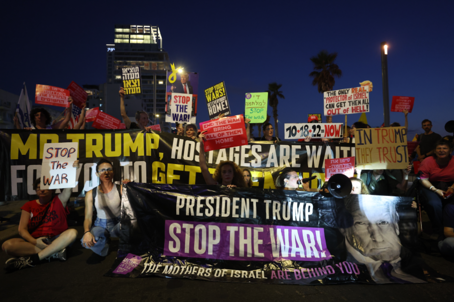 Protestors holding signs that say
