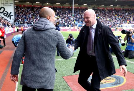 Pep Guardiola and Sean Dyche shaking hands at a soccer match.