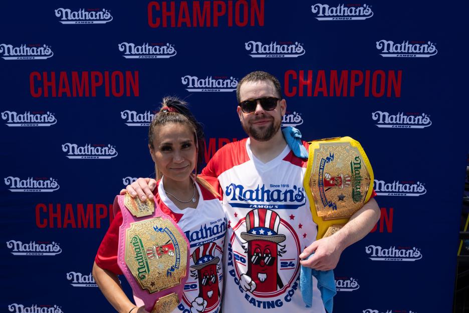 NEW YORK, NEW YORK - JULY 4: Winners Patrick Bertoletti and Miki Sudo pose for a photograph after Nathan's Annual Hot Dog Eating Contest on July 4, 2024 in New York City. Sixteen-time winner Joey Chestnut is banned from this year's contest due to his partnership with Nathan's competitor Impossible Foods, which sells plant-based hot dogs. (Photo by Adam Gray/Getty Images)