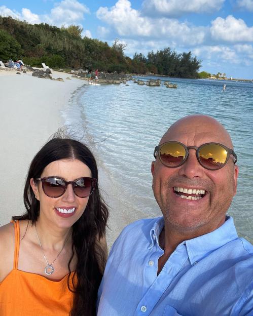 Greg Wallace and his wife on a beach.