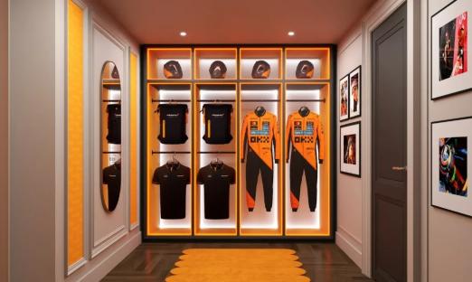 Illustration of a McLaren-themed Hilton hotel suite, including a closet with racing gear and a living area with orange furniture.