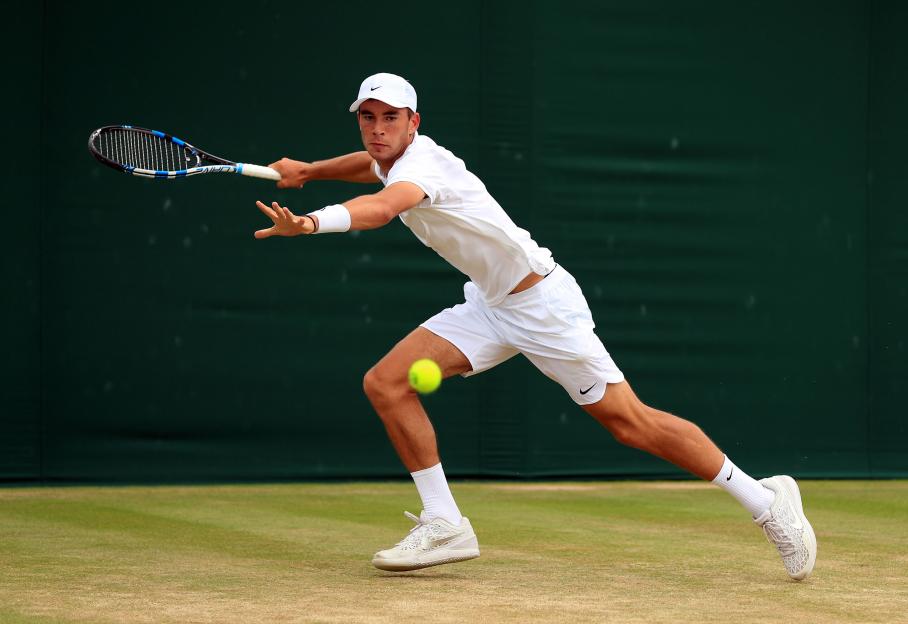 a man in a white shirt and nike shorts is playing tennis