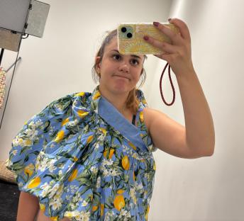 Woman trying on a lemon-print dress.