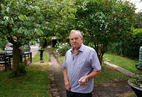 A man standing in his garden.