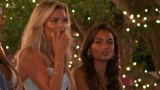 Two women reacting to a man flirting with another woman on a date.