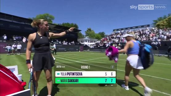 Maria Sakkari and Yulia Putintseva on a tennis court after a match.