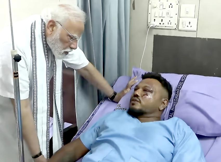 Prime Minister Narendra Modi visits a hospital and meets with a survivor of a plane crash.
