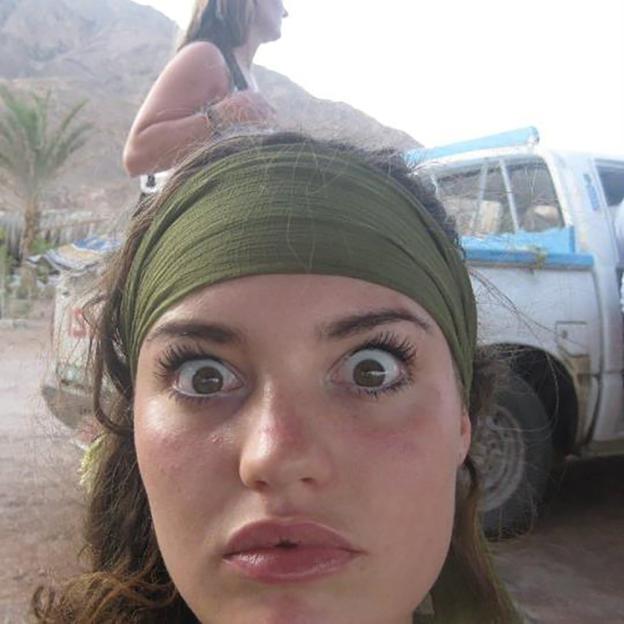 Close-up of a woman's surprised face.