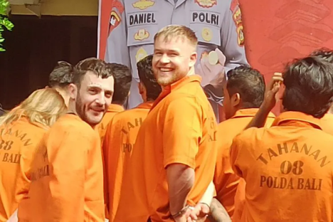 Men in orange prison jumpsuits.
