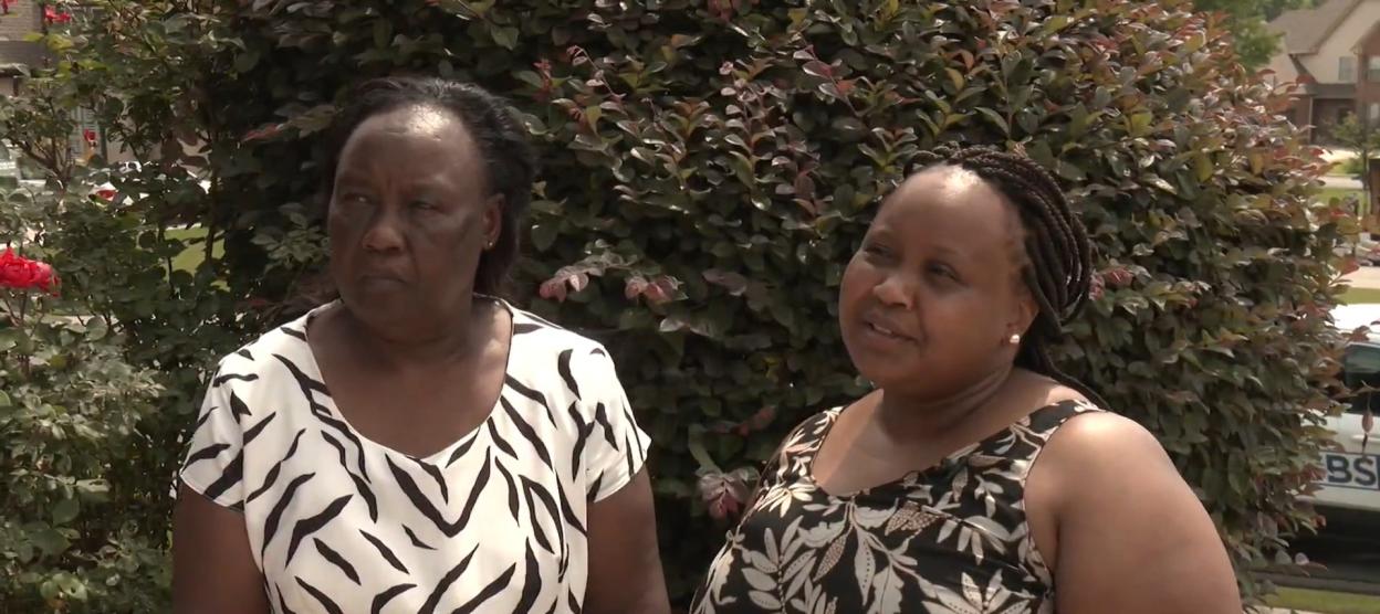 Two women being interviewed about the search for Reuben Waithaka.