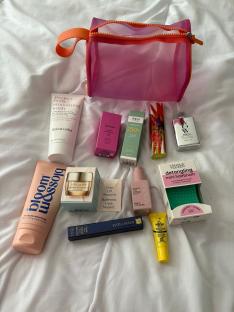 Contents of a pink mesh makeup bag.