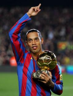 Ronaldinho holding the Ballon d'Or award.