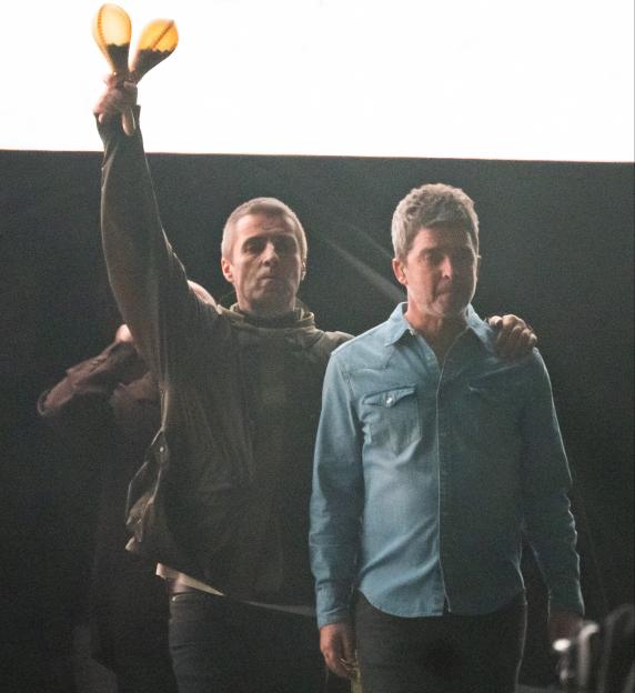 Liam and Noel Gallagher of Oasis at a concert.