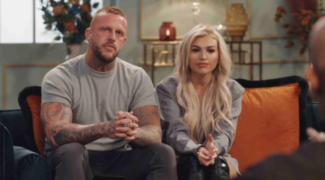 Ross and Sacha from Married At First Sight sitting on a couch.