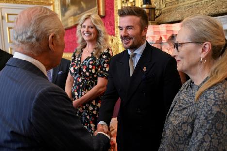 David Beckham shaking hands with King Charles at an awards ceremony.