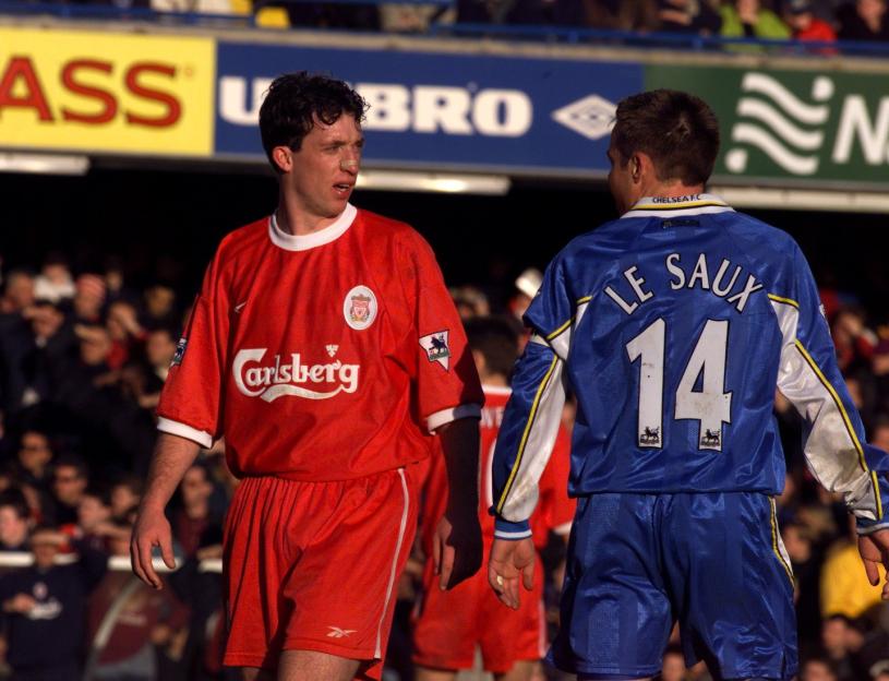 Robbie Fowler and Graeme Le Saux confronting each other on a soccer field.