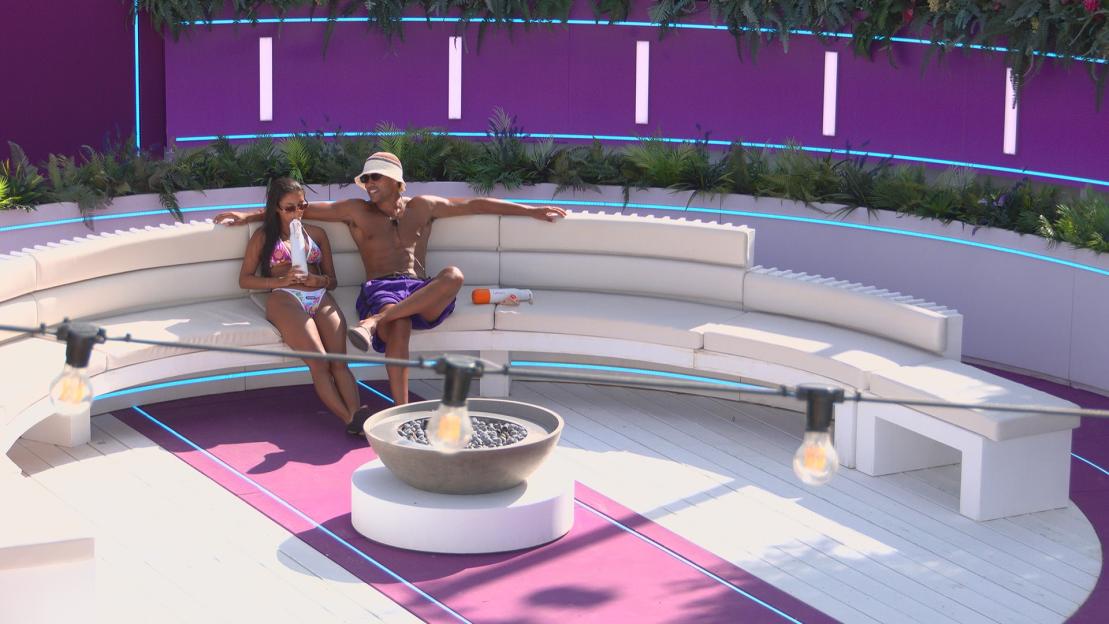 Shakira and Conor relaxing on a Love Island set.