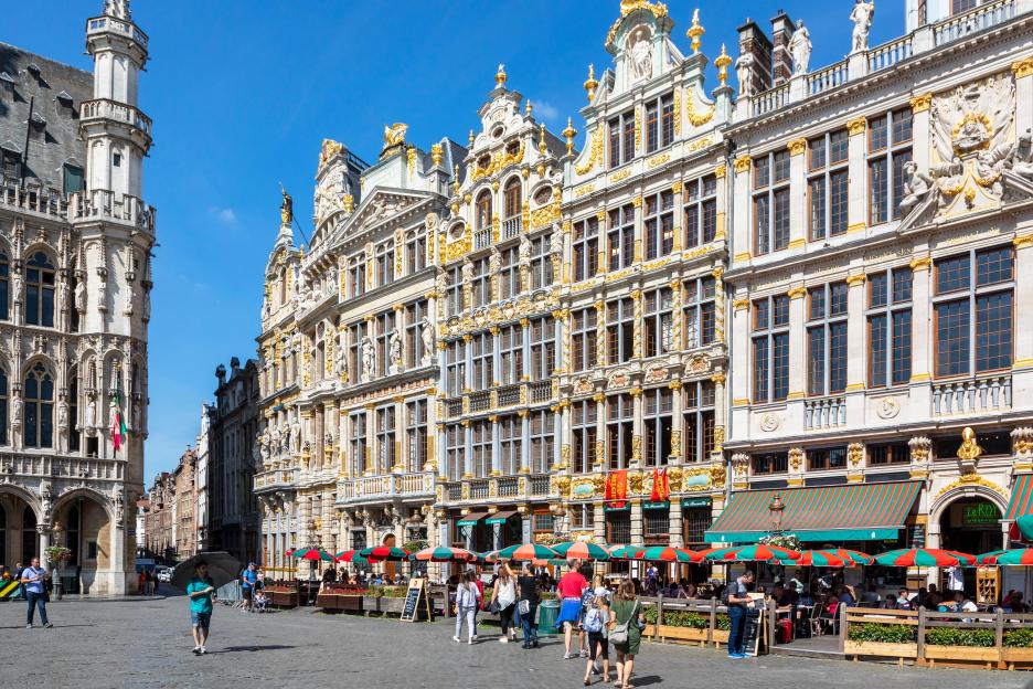 Grand Place in Brussels, Belgium, with ornate 15th-century architecture and outdoor cafes.