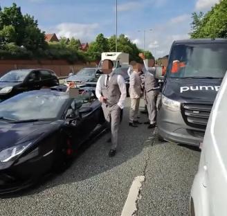A Lamborghini and wedding guests blocking a London road.