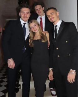 Group photo of four people in formal wear.