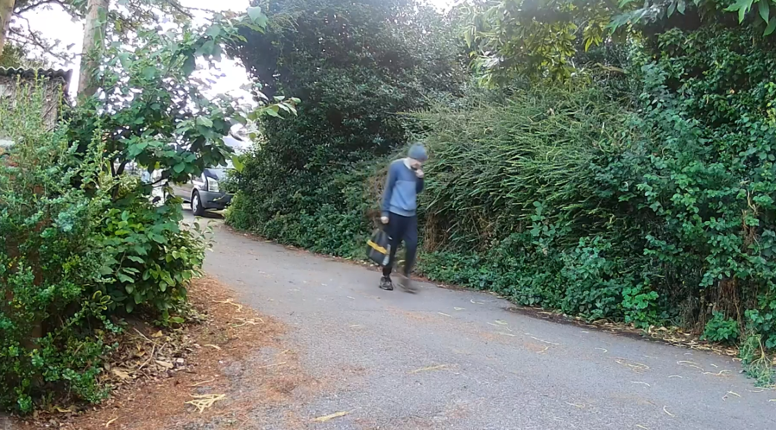 A person walking down a country lane.