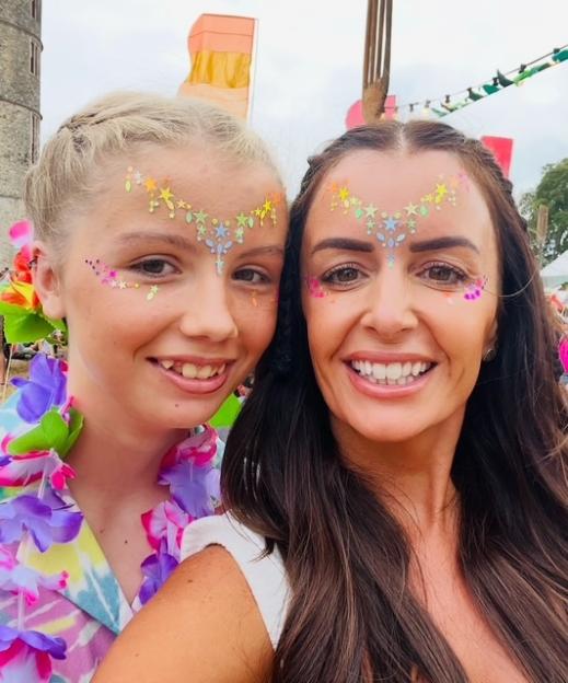Photo of a mother and daughter with sparkly face paint.