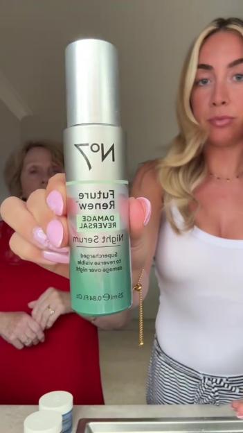 Woman holding No7 Future Renew Damage Reverse Night Serum.