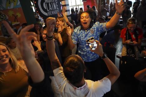 England football fans celebrating in a pub.