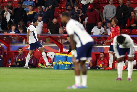 Jude Bellingham kicks Lucozade bottles after an England soccer match.
