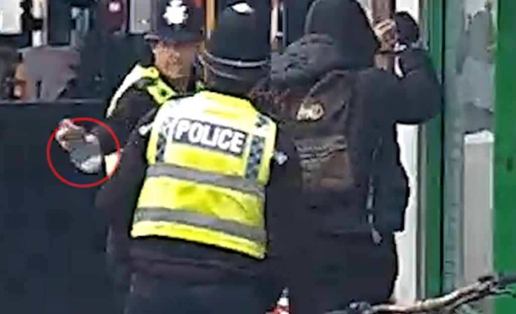 Police officer apprehending a suspect.