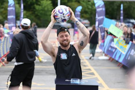 Sam Thompson holding a signed soccer ball after completing his Match Ball Mission for Soccer Aid UNICEF.