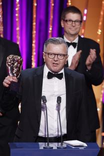 Richard Frediani accepting a BAFTA award.