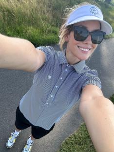 Paige Spiranac on a golf course.
