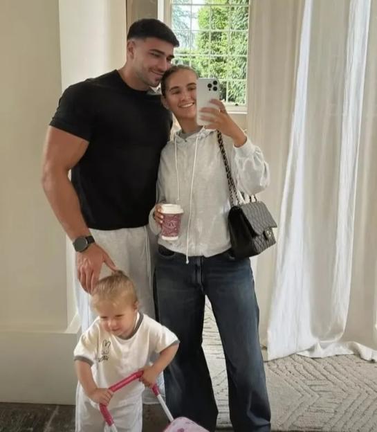 Molly-Mae, Tommy Fury, and their baby taking a selfie.