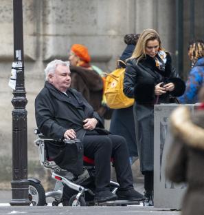 Eamonn Holmes and Katie Alexander arriving at the Louvre in Paris. Holmes is in a wheelchair.