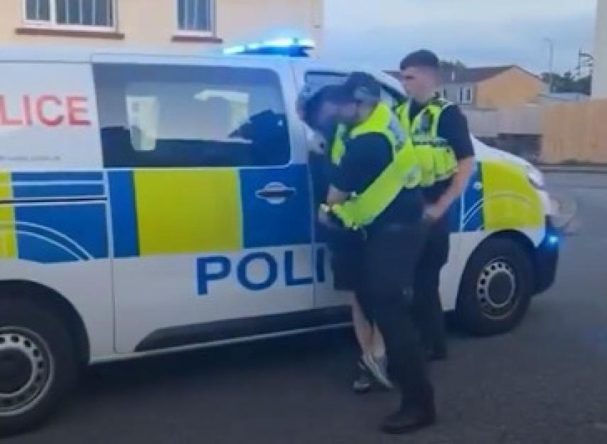 Police officer arresting a biker.