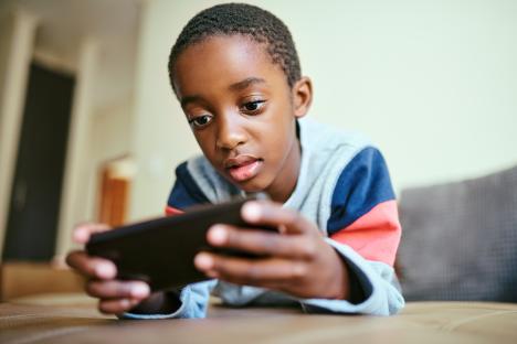 Young boy using a smartphone.