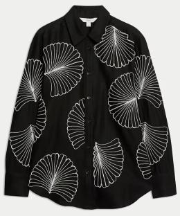 Black collared shirt with white embroidered leaf pattern.