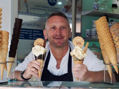Man holding two ice cream cones.