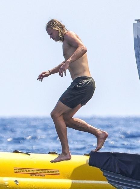 Erling Haaland stepping onto an inflatable boat.