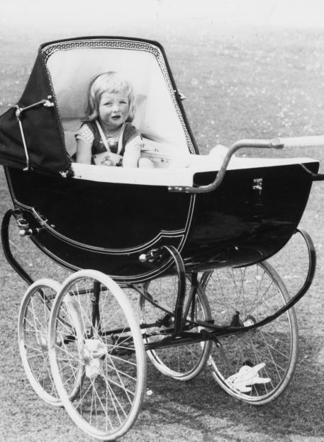 Black and white photo of Princess Diana as a toddler in a pram.