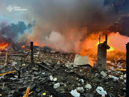 Debris and fire at a destroyed building.