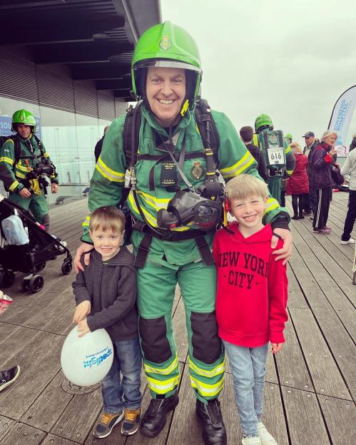 Paramedic with two young boys.