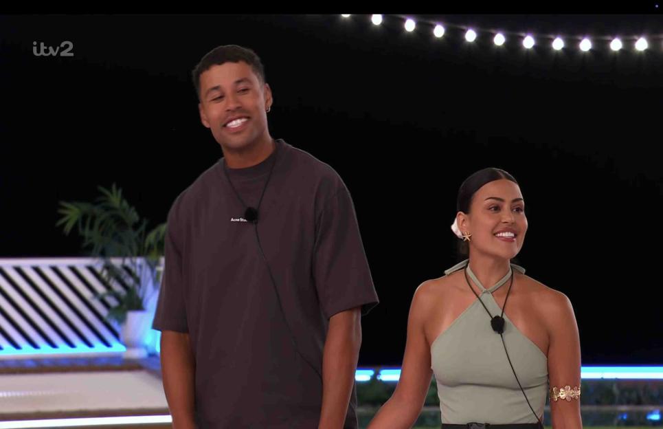 Maya Jama and a contestant holding hands at a Love Island recoupling.