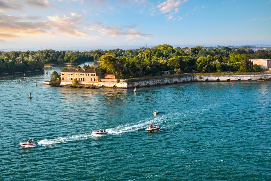 Small motorboats cruising near Poveglia island, Venice.