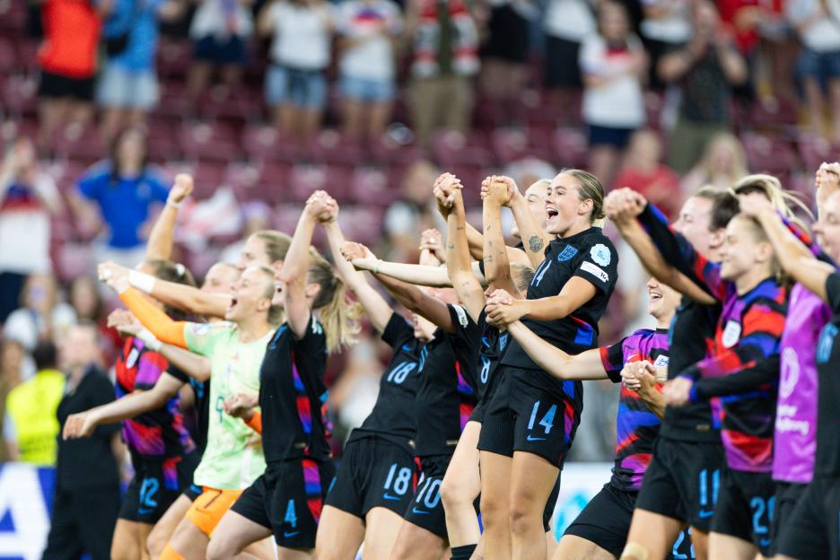 England women's soccer team celebrates a victory.