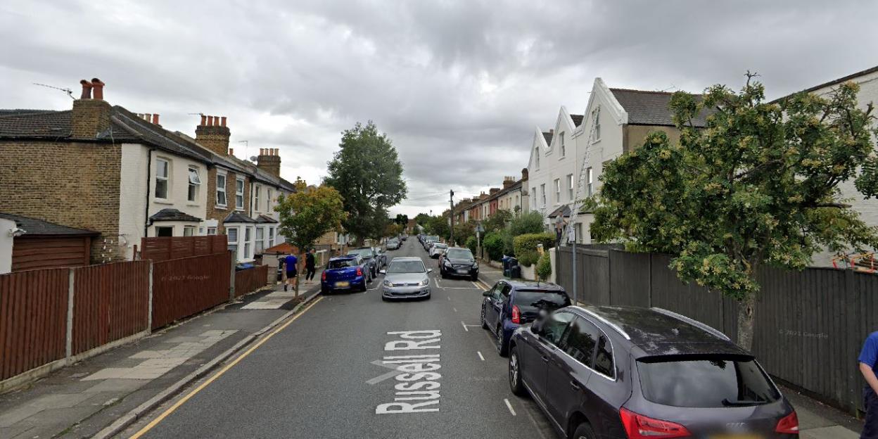 Russell Road in Wimbledon, showing residential houses and parked cars.