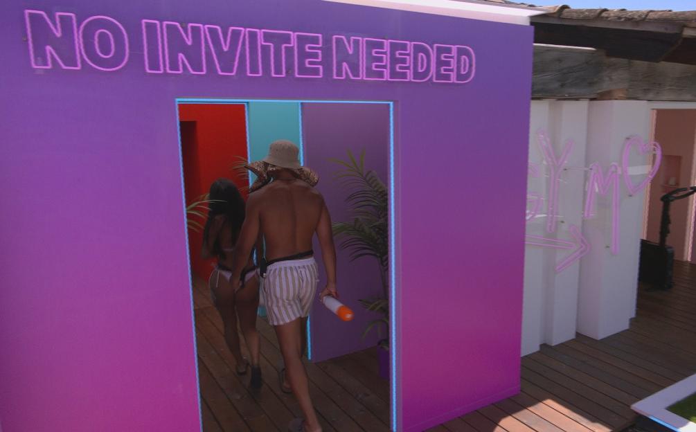 Shakira and Conor walking through a doorway with a
